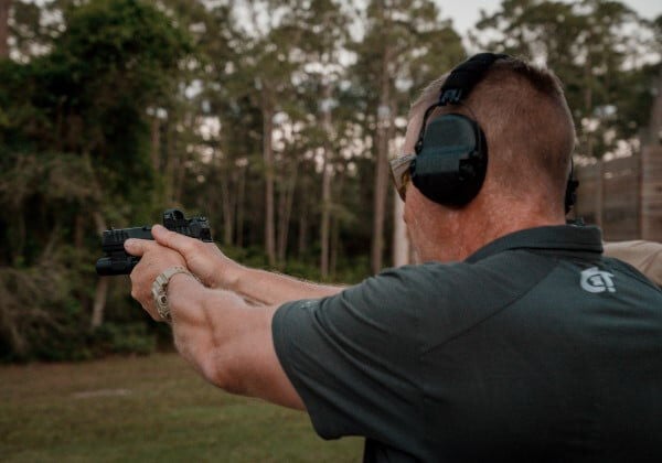 shooter aiming handgun